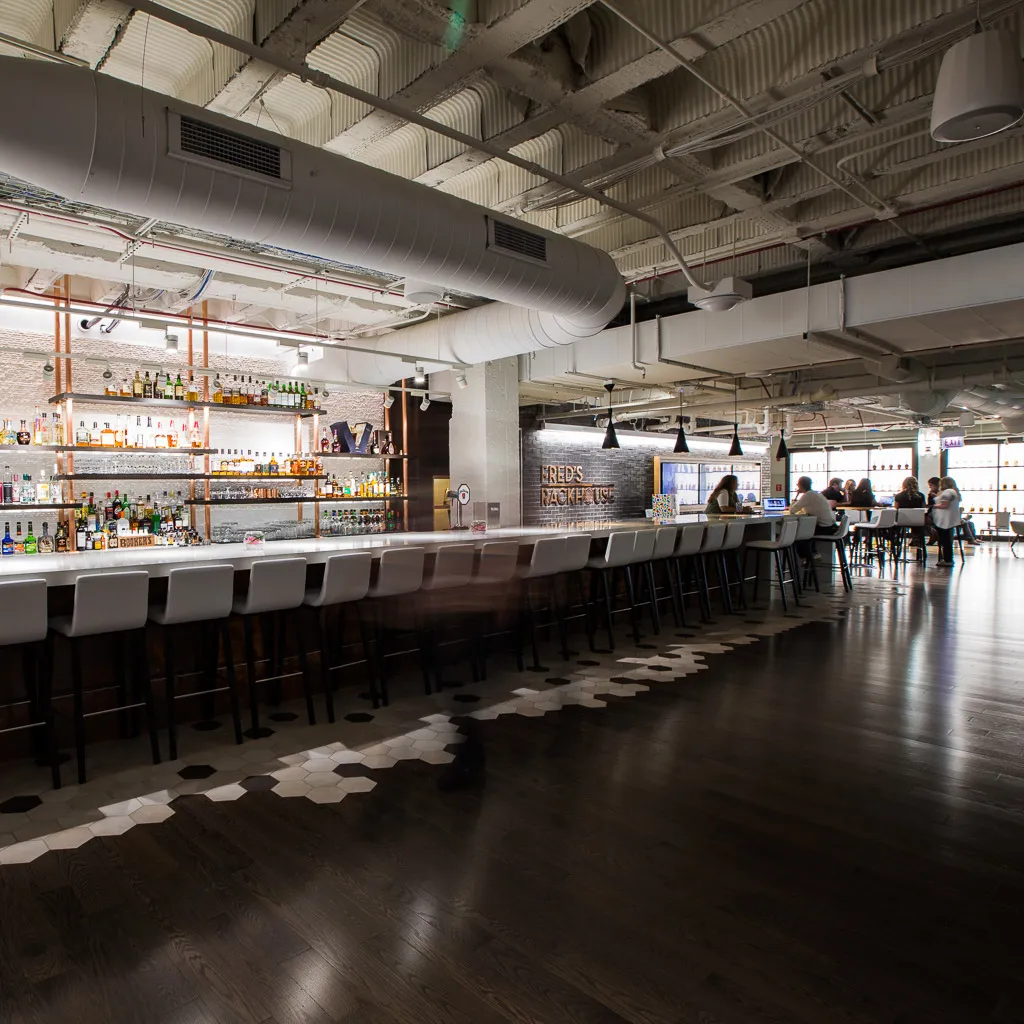 Industrial style space with a well-stocked spirits bar at the center