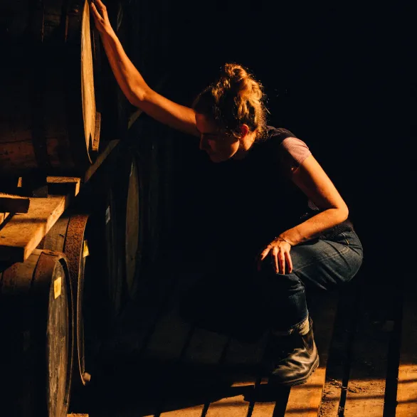 a woman looking at barrels