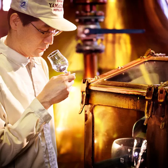 a man sniffing glass of liquor