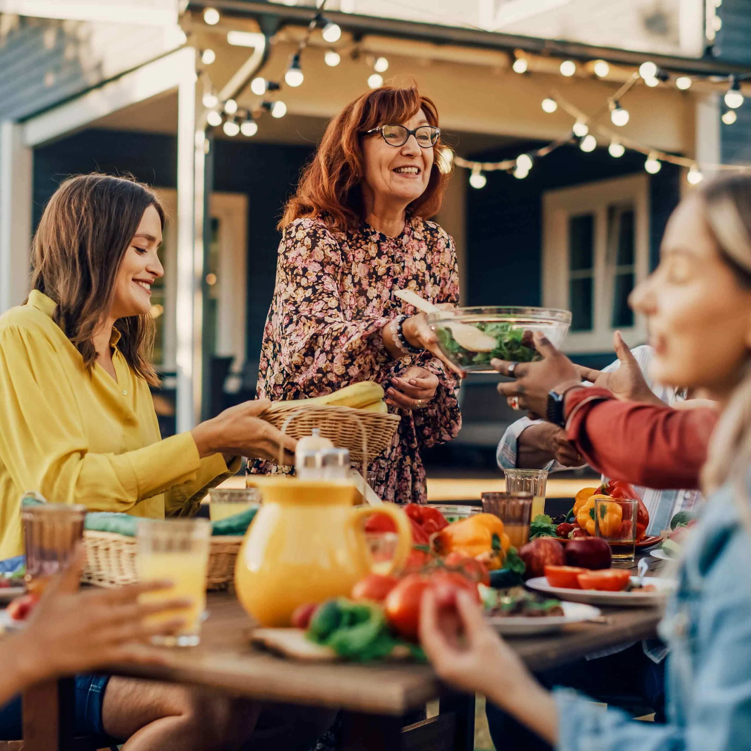 A group of people sharing a meal at an outside table.