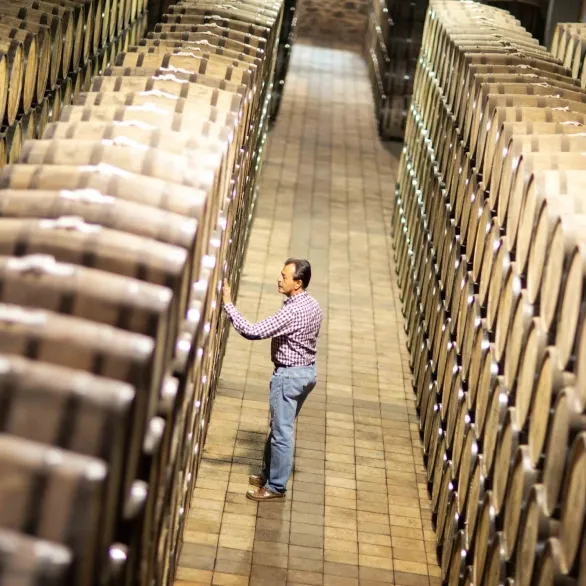 El Tesoro distillery worker examines barrel
