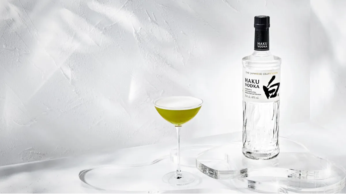 A glass and a bottle of Haku vodka